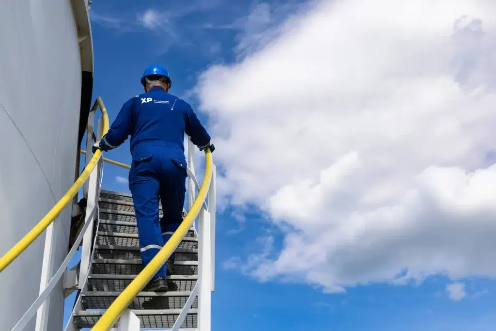 XP Group field operator inspecting gas-to-power infrastructure to support gas flaring monetization and emissions reduction.