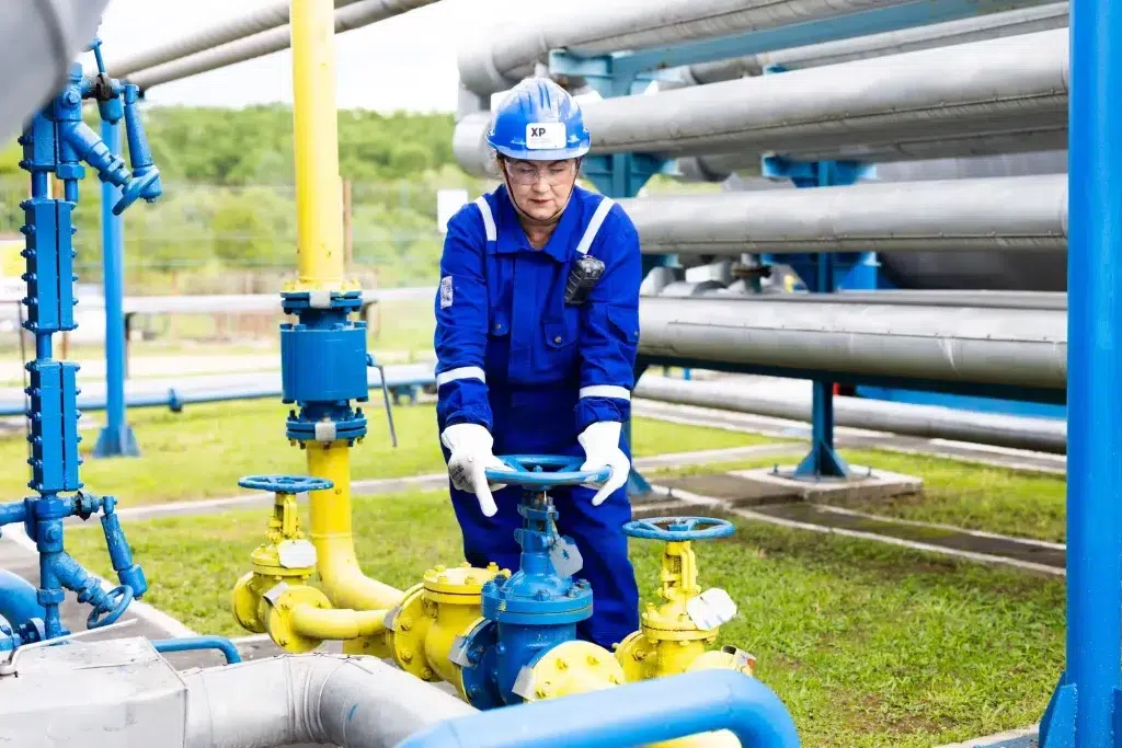 XP Group technician operating field production equipment to improve efficiency and optimize oil and gas operations.
